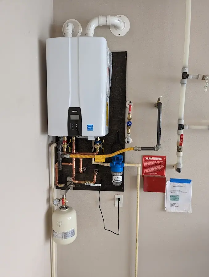 Professional plumber installing copper piping in a San Diego home